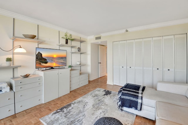 interior space featuring light parquet flooring, crown molding, and a closet