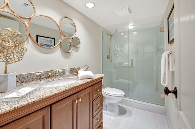 bathroom featuring vanity, toilet, and a shower with shower door