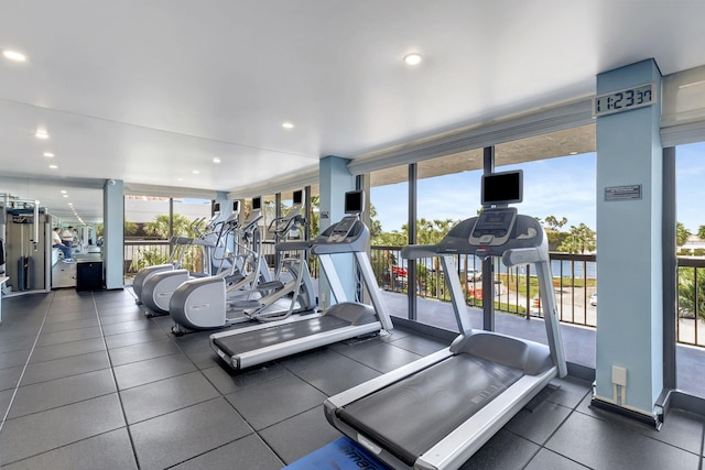 workout area featuring plenty of natural light and floor to ceiling windows