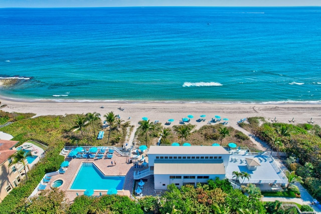 birds eye view of property with a beach view and a water view