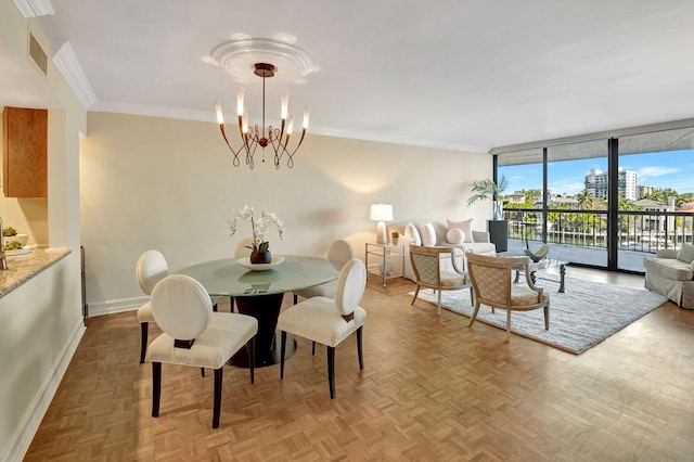 dining area with ornamental molding, parquet flooring, a chandelier, and a wall of windows