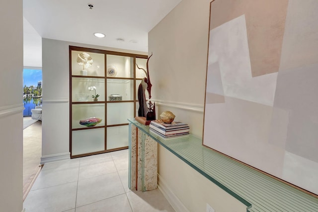 hall with light tile patterned floors