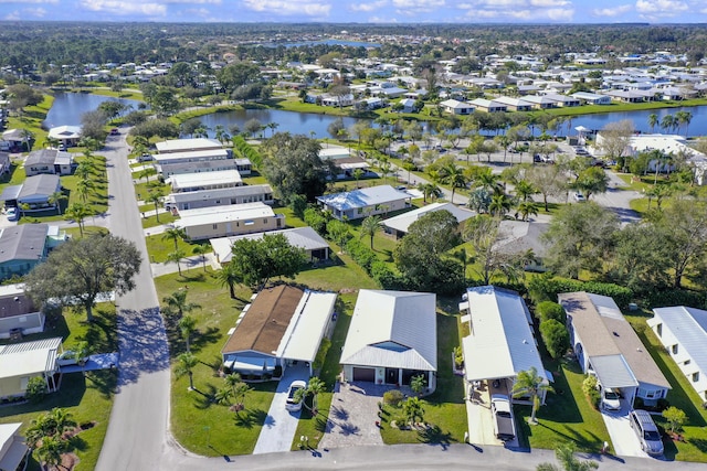 birds eye view of property with a water view and a residential view