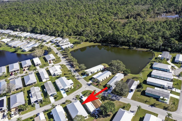 drone / aerial view with a water view and a residential view