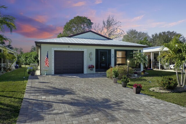 view of front of home with a garage and a front yard