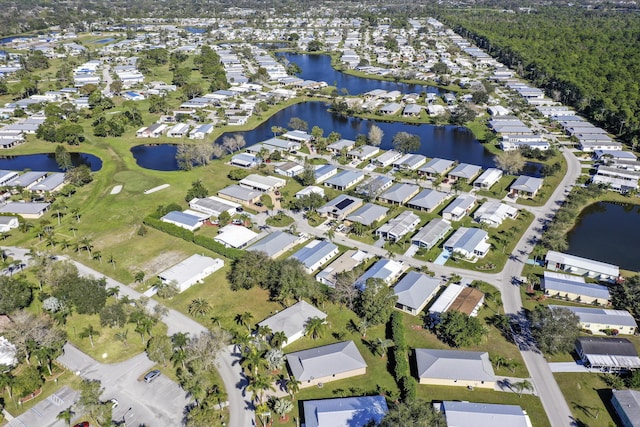 drone / aerial view with a residential view and a water view