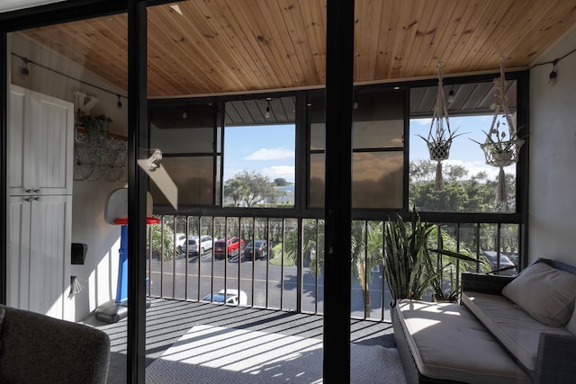 sunroom featuring a wealth of natural light and wooden ceiling