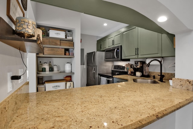 kitchen featuring green cabinets, stainless steel appliances, kitchen peninsula, and sink