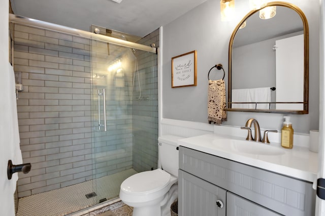 bathroom featuring vanity, toilet, and an enclosed shower