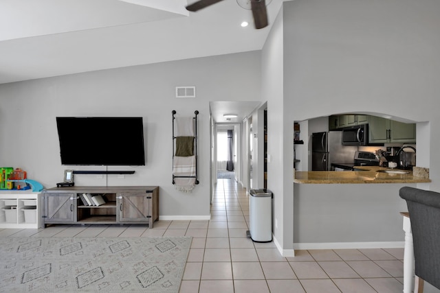 tiled living room with high vaulted ceiling, sink, and ceiling fan