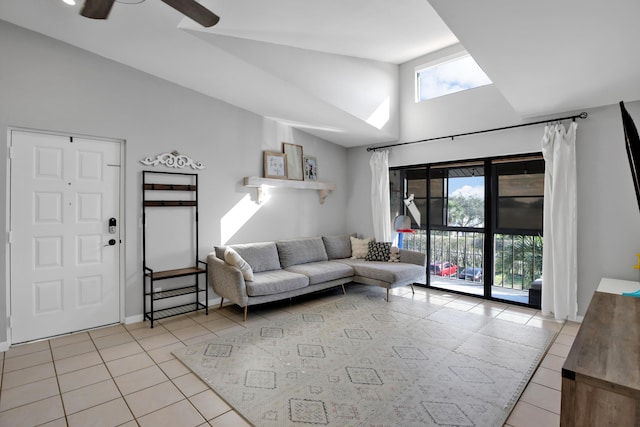 tiled living room featuring high vaulted ceiling and ceiling fan