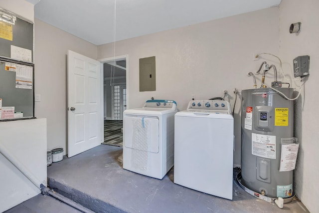 clothes washing area with electric water heater, electric panel, and washer and clothes dryer