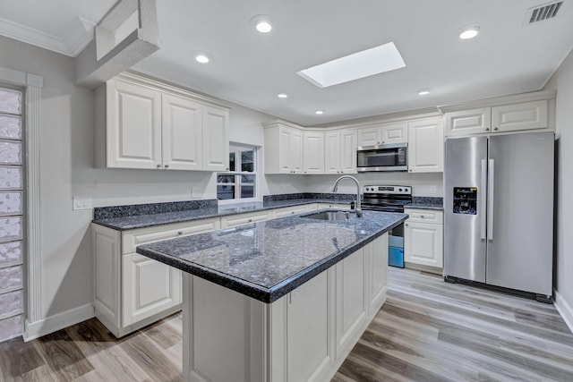 kitchen with white cabinetry, sink, an island with sink, and appliances with stainless steel finishes