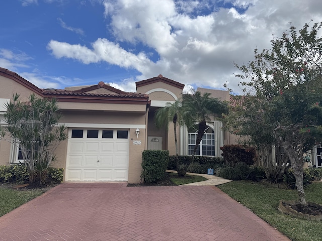 mediterranean / spanish-style home with a garage