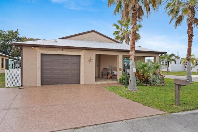 view of front of house with a garage and a front yard