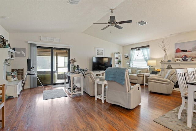 living room featuring ceiling fan, dark wood-type flooring, a textured ceiling, and vaulted ceiling