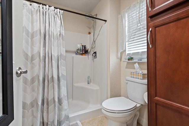 bathroom with curtained shower and toilet