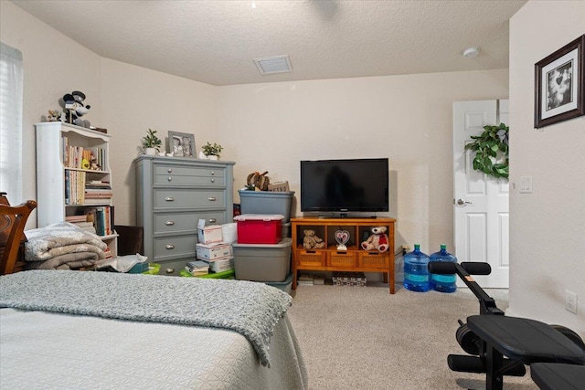 carpeted bedroom featuring a textured ceiling