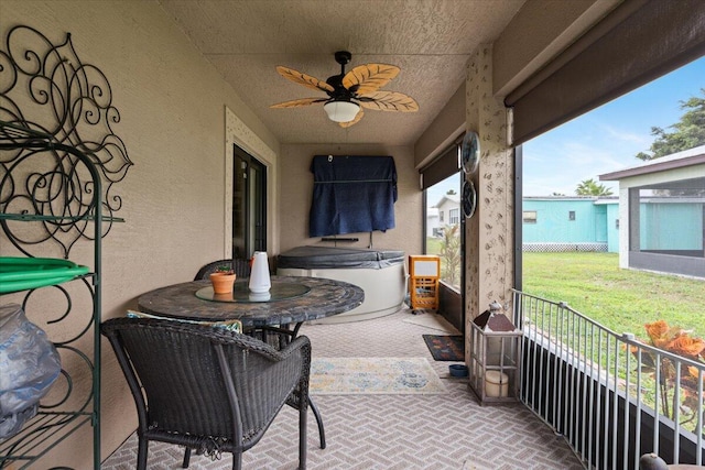 view of patio with ceiling fan and a hot tub