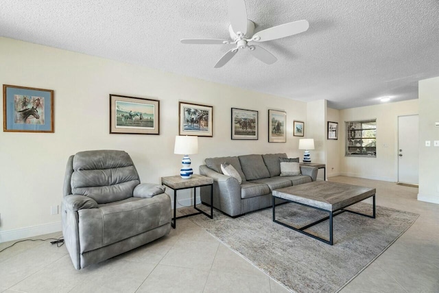 living room with ceiling fan, a textured ceiling, and light tile patterned floors