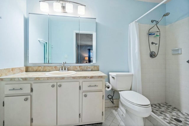 bathroom with tile patterned floors, vanity, toilet, and a shower with shower curtain