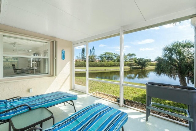 sunroom / solarium featuring a water view