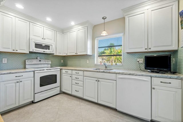 kitchen with sink, light tile patterned floors, pendant lighting, white appliances, and white cabinets