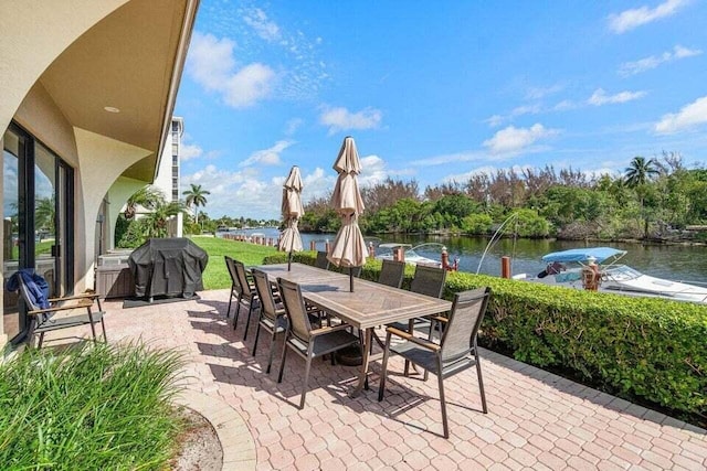 view of patio with a water view and grilling area