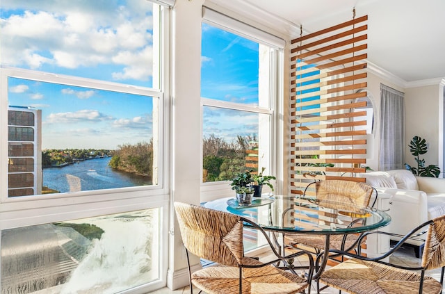 sunroom / solarium featuring a water view