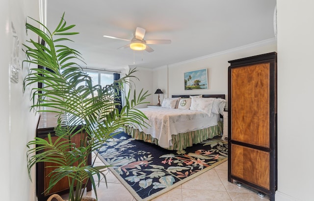 tiled bedroom featuring ornamental molding and ceiling fan