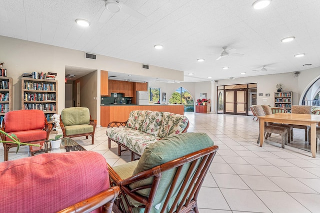 living room with light tile patterned floors and ceiling fan