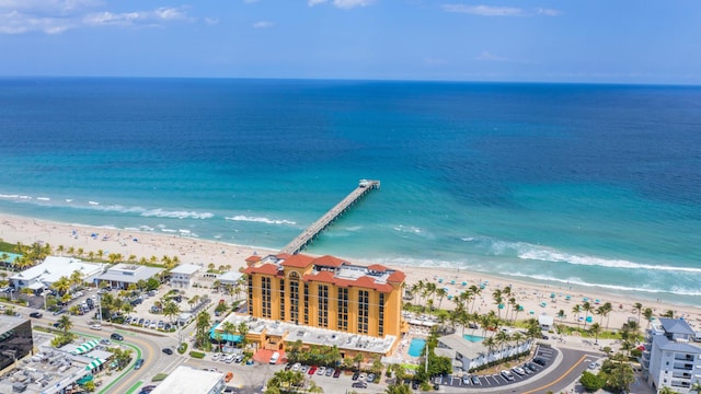 birds eye view of property with a water view and a view of the beach