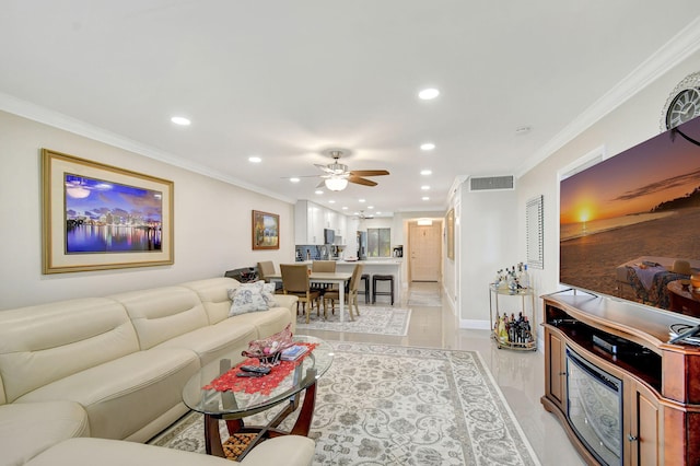 living room featuring crown molding and ceiling fan