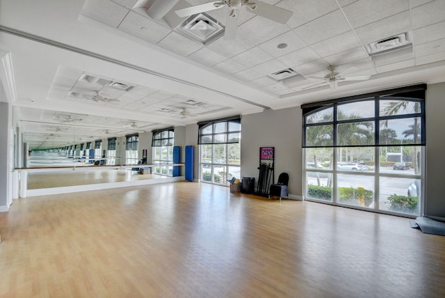 interior space featuring ceiling fan, a wall of windows, and hardwood / wood-style floors