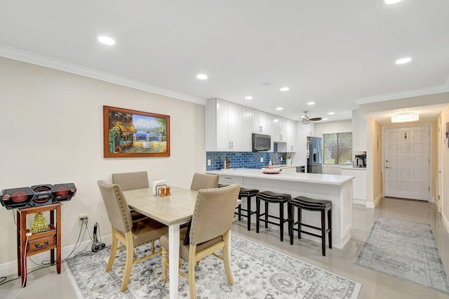 dining space featuring ornamental molding and ceiling fan