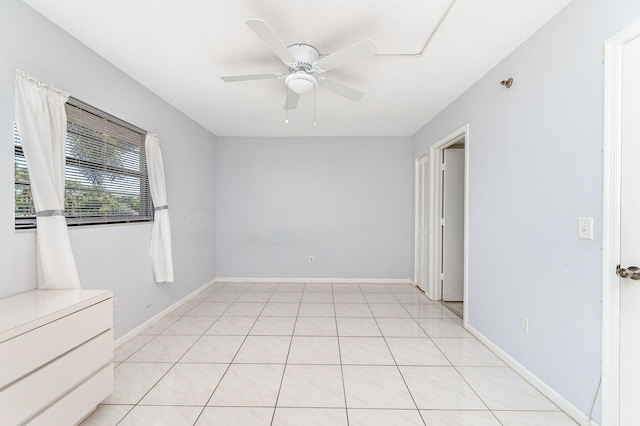 tiled empty room with ceiling fan