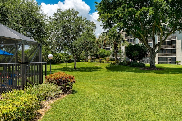 view of yard featuring glass enclosure