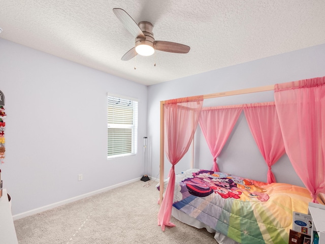 bedroom featuring ceiling fan, light colored carpet, and a textured ceiling