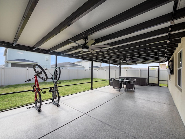 unfurnished sunroom with ceiling fan