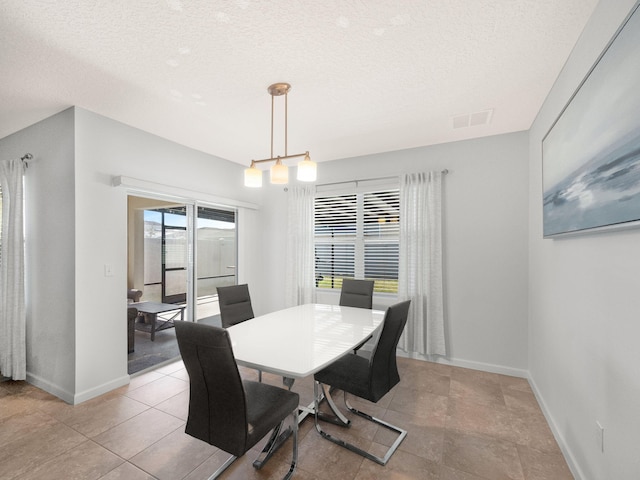 dining room featuring a textured ceiling