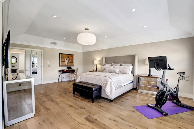 bedroom featuring crown molding and light hardwood / wood-style flooring