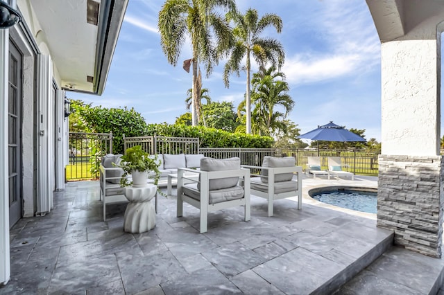 view of patio / terrace with a fenced in pool and outdoor lounge area