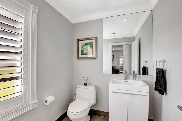 bathroom featuring ornamental molding, toilet, and vanity