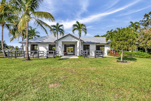 rear view of property featuring a yard