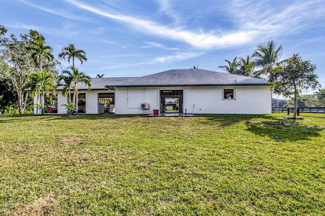 back of house with a lawn