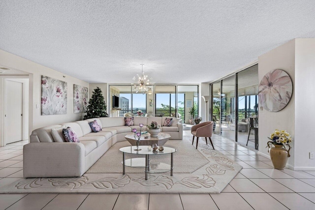 living room with floor to ceiling windows, light tile patterned floors, a notable chandelier, and a textured ceiling