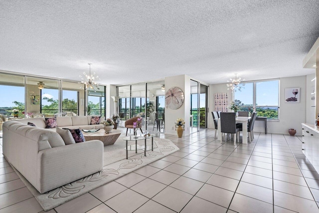 tiled living room featuring a textured ceiling and a notable chandelier