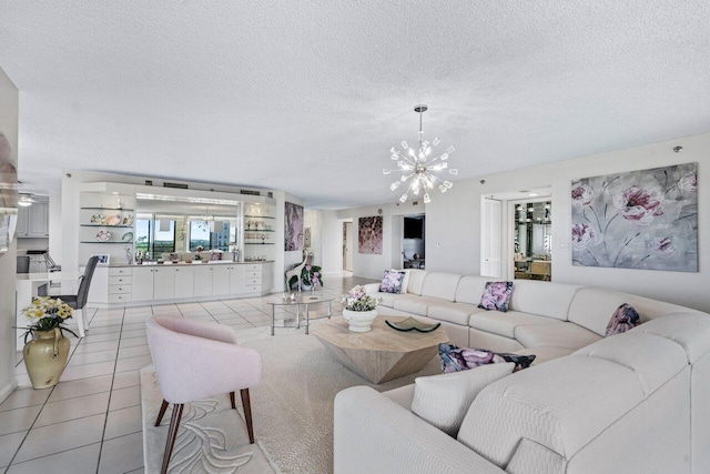 tiled living room with an inviting chandelier and a textured ceiling