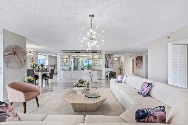 tiled living room featuring a notable chandelier and a textured ceiling