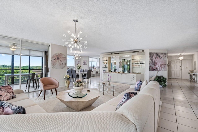 tiled living room featuring an inviting chandelier, a textured ceiling, and a wealth of natural light